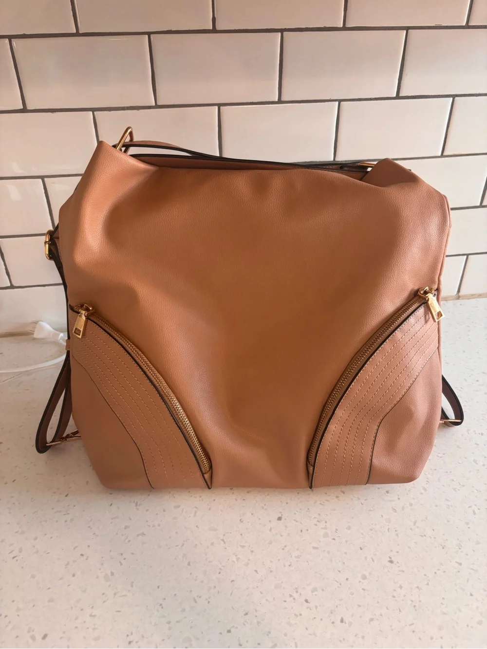 Tan Leatherette Shoulder Bag with Front Zip Pockets. Hand strap or backpack